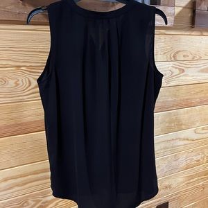 Double pleated button-down sleeveless blouse